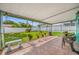 Covered porch features neutral tiling, ample sunlight, and room for patio furniture at 5107 Pine St, Seffner, FL 33584
