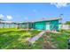 View of spacious backyard with a screened in porch, a white door, and green grass at 5107 Pine St, Seffner, FL 33584