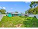 Spacious backyard features a screened in patio and lush green lawn under a clear blue sky at 5107 Pine St, Seffner, FL 33584