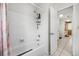 Clean bathroom with tiled walls, a shower-tub combo, and neutral decor at 5107 Pine St, Seffner, FL 33584
