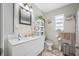Bathroom featuring double sink vanity with tile flooring and framed mirror at 5107 Pine St, Seffner, FL 33584