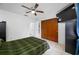 Cozy bedroom featuring ceiling fan, mounted TV, and spacious closet for all of your storage needs at 5107 Pine St, Seffner, FL 33584