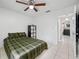 Cozy bedroom with a ceiling fan and light tile flooring at 5107 Pine St, Seffner, FL 33584