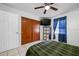 Bedroom with blue window shade featuring ceiling fan and large closet for storage at 5107 Pine St, Seffner, FL 33584