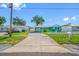 Single-story turquoise home with an American flag, carport, and white picket fence at 5107 Pine St, Seffner, FL 33584