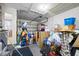 View of the garage with garage door, overhead lighting, and ample storage space for tools and equipment at 5107 Pine St, Seffner, FL 33584