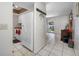 Bright kitchen featuring white appliances, tile flooring, and a sliding door to the outdoor space at 5107 Pine St, Seffner, FL 33584