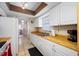 Functional kitchen with bright white cabinets, wood countertops, and modern appliances at 5107 Pine St, Seffner, FL 33584