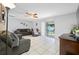 Inviting living room with tile flooring, ceiling fan, comfortable seating, and access to the backyard at 5107 Pine St, Seffner, FL 33584