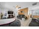 Spacious living room featuring tile floors, ceiling fan, comfortable sofas, and a mounted television at 5107 Pine St, Seffner, FL 33584