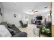 Bright living room with tile floors, ceiling fan, comfortable seating, and sliding glass doors to the outdoors at 5107 Pine St, Seffner, FL 33584