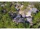 Aerial view shows property's roof, driveway, surrounding trees, and neighborhood homes at 5340 Cobblestone Ct, Wesley Chapel, FL 33543