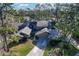 Aerial view of house showing roof, garage and surrounding trees and lawn at 5340 Cobblestone Ct, Wesley Chapel, FL 33543