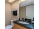 Cozy powder room with granite countertop, wood cabinet, and a convenient toilet at 5340 Cobblestone Ct, Wesley Chapel, FL 33543