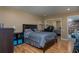 Bedroom featuring a large bed, mirrored closet doors, and hardwood floors at 5340 Cobblestone Ct, Wesley Chapel, FL 33543