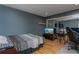 Bedroom featuring hardwood floors, a mirrored closet, and a sleek gray color scheme at 5340 Cobblestone Ct, Wesley Chapel, FL 33543