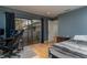 Bedroom featuring hardwood floors, a sliding glass door, and a sleek gray color scheme at 5340 Cobblestone Ct, Wesley Chapel, FL 33543
