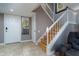 Bright entryway with a staircase, white door, and tile flooring, offering a welcoming entrance to the home at 5340 Cobblestone Ct, Wesley Chapel, FL 33543