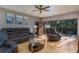Cozy living room features hardwood floors, leather seating, and natural light from a sliding glass door at 5340 Cobblestone Ct, Wesley Chapel, FL 33543