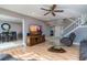 Open-concept living room boasts hardwood floors, a ceiling fan, and seamless access to the dining area at 5340 Cobblestone Ct, Wesley Chapel, FL 33543