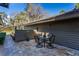 Outdoor patio area with stone flooring, complete with a table and chairs for relaxing or entertaining guests at 5340 Cobblestone Ct, Wesley Chapel, FL 33543