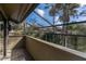 Cozy screened porch with wooden floors offers a relaxing outdoor space with a view of trees at 5340 Cobblestone Ct, Wesley Chapel, FL 33543