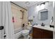Cozy bathroom with shower-tub combo, dark fixtures, and a single sink vanity at 5346 Black Pine Dr, Tampa, FL 33624