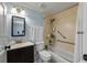 Bathroom featuring a tub and shower combination with grab bars and a sink with vanity at 5346 Black Pine Dr, Tampa, FL 33624