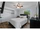 Bright bedroom features a queen bed, ceiling fan, and ample natural light from the window at 5346 Black Pine Dr, Tampa, FL 33624
