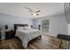 Light filled bedroom with wood-look floors, ceiling fan, and light blue walls at 5346 Black Pine Dr, Tampa, FL 33624