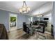 Dining room with a glass table, mirrored wall, and a modern chandelier at 5346 Black Pine Dr, Tampa, FL 33624