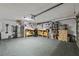 Spacious garage featuring a workbench, storage, and a refrigerator at 5346 Black Pine Dr, Tampa, FL 33624