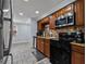 Spacious kitchen boasts wood cabinets, stainless steel appliances, and granite countertops at 5346 Black Pine Dr, Tampa, FL 33624
