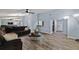 Bright living room boasts wood floors, large windows, and stylish furnishings at 5346 Black Pine Dr, Tampa, FL 33624
