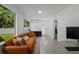 Bright office space features large windows, and a comfortable orange couch at 5346 Black Pine Dr, Tampa, FL 33624