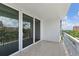 Spacious outdoor balcony with tiled floor, with views of the city and greenery from large sliding glass doors at 700 Beach Ne Dr # 606, St Petersburg, FL 33701