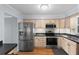 Bright kitchen featuring stainless steel appliances, wood cabinets, and ample counter space with modern fixtures at 700 Beach Ne Dr # 606, St Petersburg, FL 33701