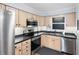 Well-lit kitchen features stainless steel appliances and light wood cabinets at 700 Beach Ne Dr # 606, St Petersburg, FL 33701