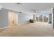 Spacious living room with neutral carpet, ceiling fan, and large windows offering plenty of natural light and an attached bathroom at 700 Beach Ne Dr # 606, St Petersburg, FL 33701