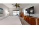Comfortable bedroom with neutral colors, a ceiling fan, and windows offering outdoor views at 7010 Kendall Heath Way, Land O Lakes, FL 34637