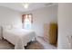 A cozy bedroom with a light-colored dresser and neutral carpet at 7010 Kendall Heath Way, Land O Lakes, FL 34637