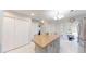 Well-lit kitchen with a center island, lots of storage, and a clear view into the sunroom at 7010 Kendall Heath Way, Land O Lakes, FL 34637