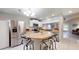 Well-lit kitchen featuring stainless steel appliances, tiled floors, and breakfast bar at 7010 Kendall Heath Way, Land O Lakes, FL 34637