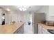 Modern kitchen with ample counter space, stainless steel appliances, and a seamless transition to the dining area at 7010 Kendall Heath Way, Land O Lakes, FL 34637