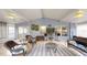 Bright and airy Lanai furnished with seating, neutral paint, and two ceiling fans at 7010 Kendall Heath Way, Land O Lakes, FL 34637