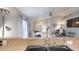 Bright living room showcasing modern finishes and an open floor plan with a view into the kitchen at 7010 Kendall Heath Way, Land O Lakes, FL 34637
