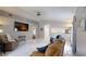 Open-concept living room with high ceilings, tile floors, and a large TV at 7010 Kendall Heath Way, Land O Lakes, FL 34637