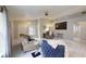Open-concept living room with high ceilings, tile floors, and a large TV at 7010 Kendall Heath Way, Land O Lakes, FL 34637
