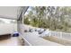 Outdoor patio with a grill, lounging furniture, and views of the natural surroundings at 7010 Kendall Heath Way, Land O Lakes, FL 34637