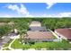 Aerial view of a home with a well-maintained lawn and landscaping, blending seamlessly into a lush, green neighborhood at 7101 Bucks Ford Dr, Riverview, FL 33578